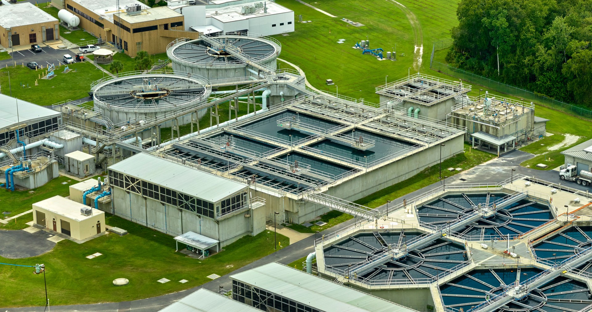 Aerial view of modern water cleaning facility at urban wastewater treatment plant. Purification process of removing undesirable chemicals, suspended solids and gases from contaminated liquid