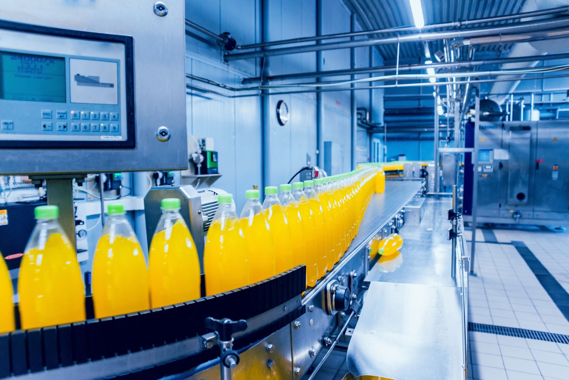 Beverage factory interior. Conveyor with bottles for juice or water. Equipments