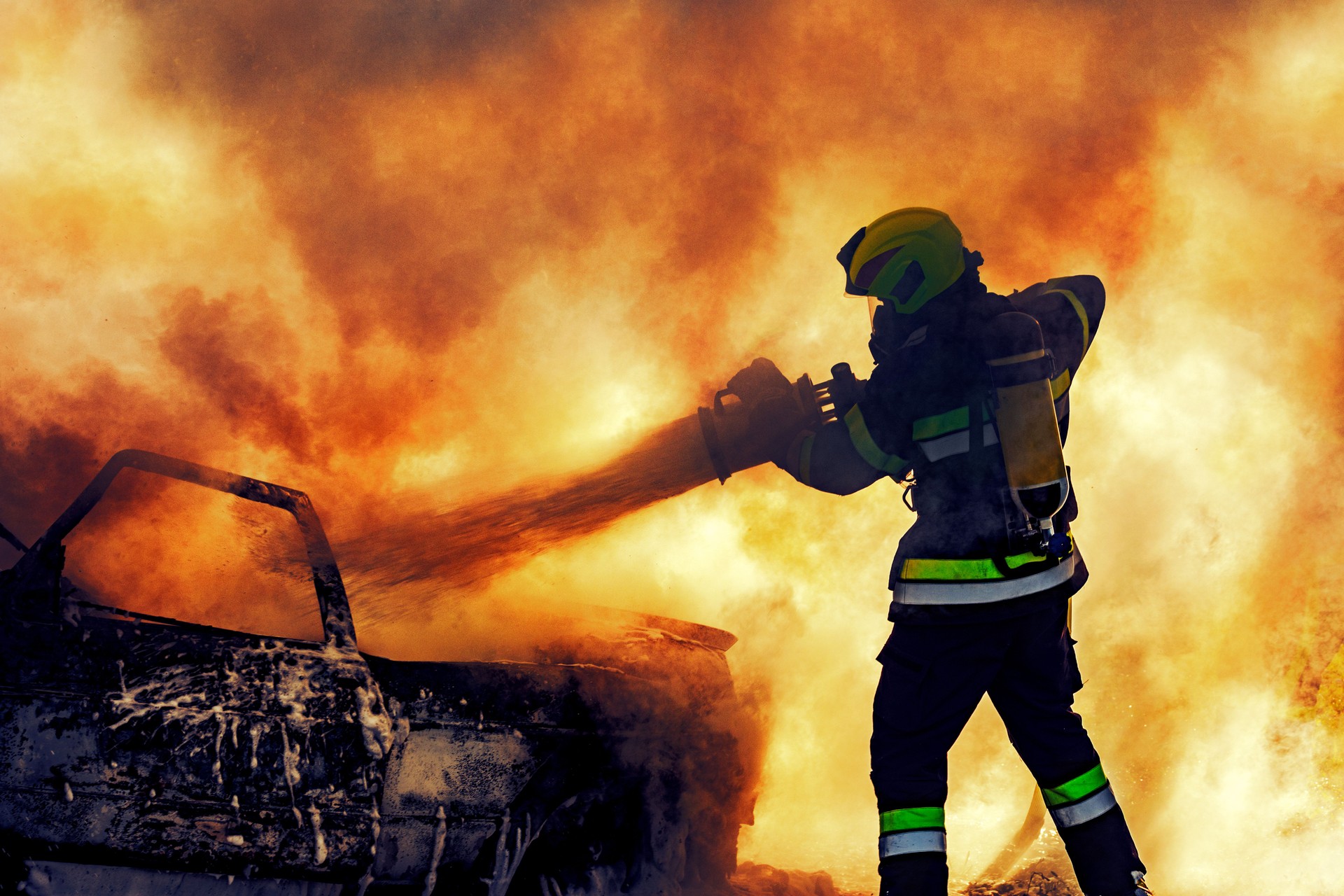 Firefighter extinguishing fire - real hero concept