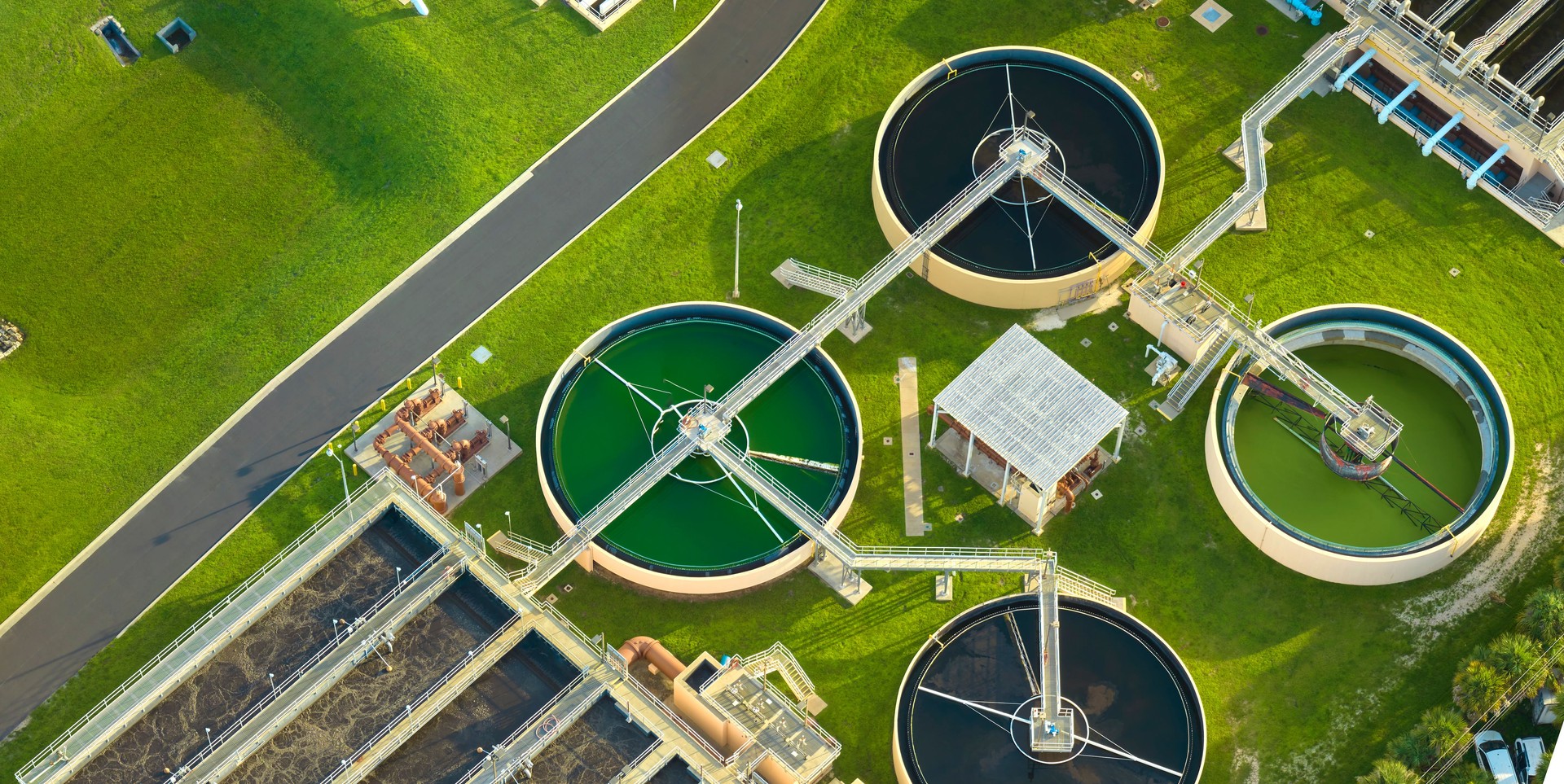 Aerial view of modern water cleaning facility at urban wastewater treatment plant. Purification process of removing undesirable chemicals, suspended solids and gases from contaminated liquid